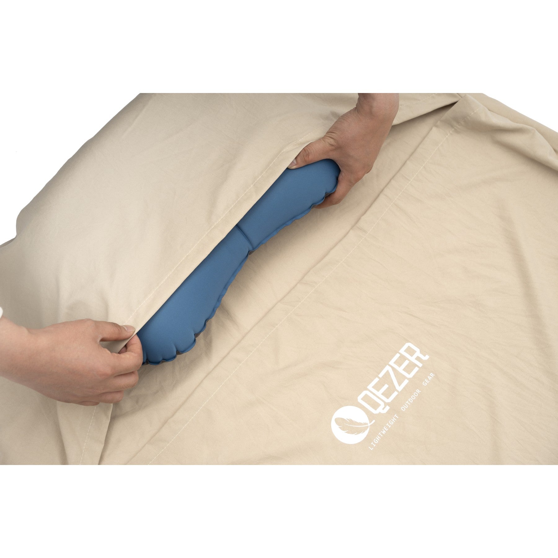 Built-in pillow pocket holding an inflatable pillow inside a QEZER sleeping bag liner