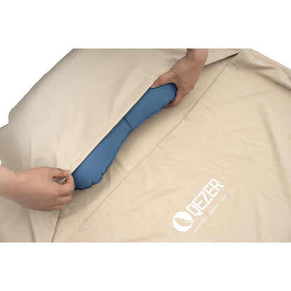 Built-in pillow pocket holding an inflatable pillow inside a QEZER sleeping bag liner