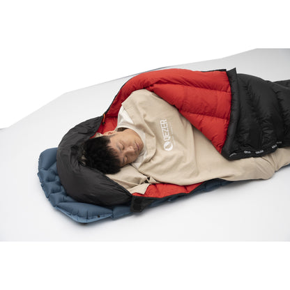 Camper using a QEZER khaki sleeping bag liner inside a mummy sleeping bag