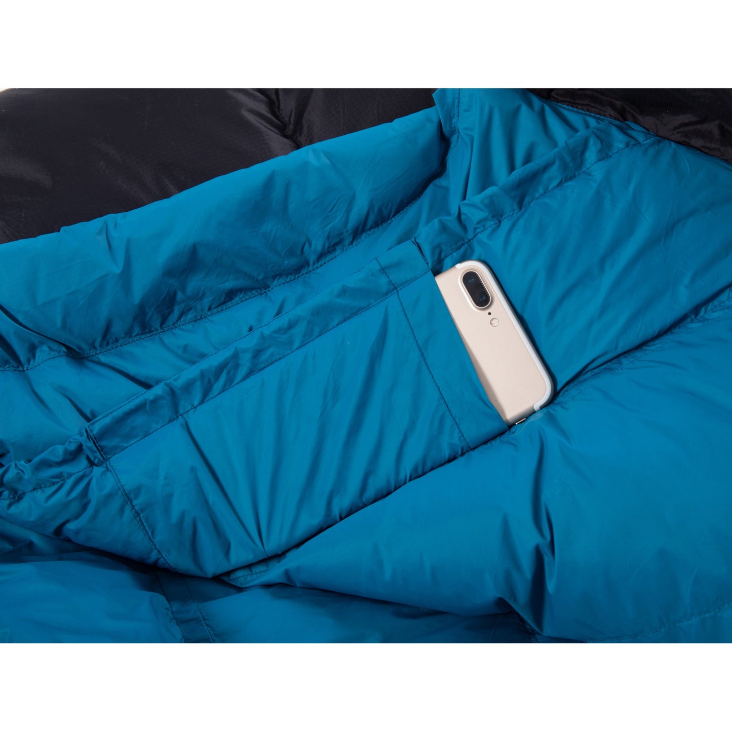 Inner storage pocket holding a smartphone inside a QEZER mummy sleeping bag