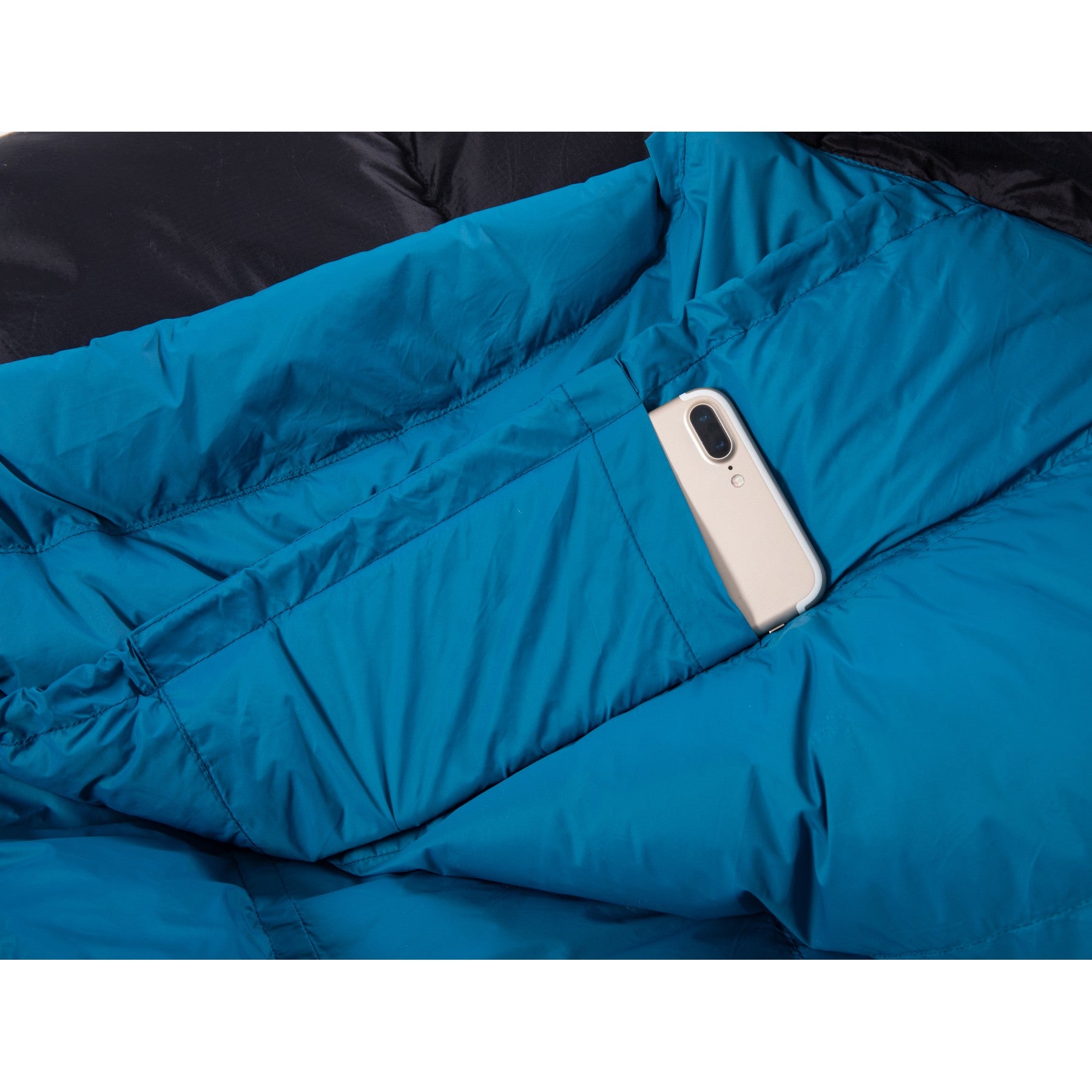 Inner storage pocket holding a smartphone inside a QEZER mummy sleeping bag