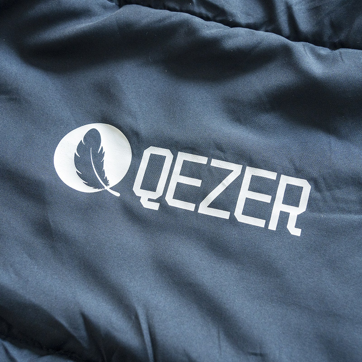 QEZER deep blue rectangular sleeping bag, fully unzipped flat like a blanket