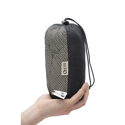 QEZER ultralight sleeping bag liner packed in a compact mesh storage pouch