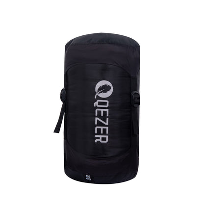 QEZER winter mummy sleeping bag packed in a black compression sack