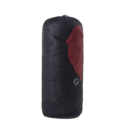 Side view of QEZER black compression sack with packed winter sleeping bag