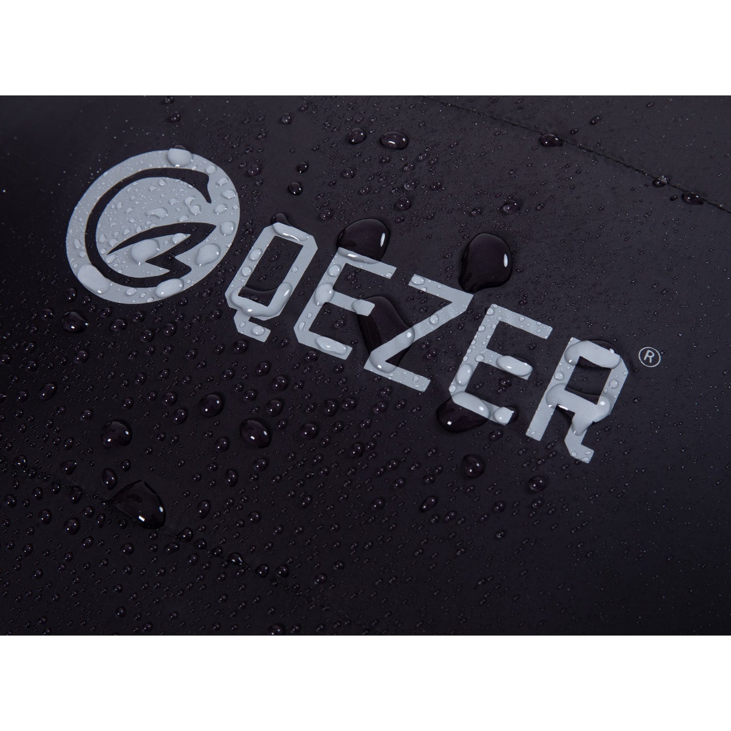 Water droplets on the black nylon shell and QEZER logo of a mummy down sleeping bag
